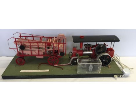 A Wilesco "Old Smoky" live steam engine mounted on board with a working model of a 1926 Ransom class "A" Thresher.
