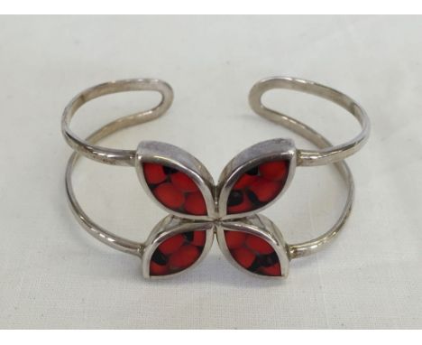 A Spanish 850 silver bangle set with red seeds.