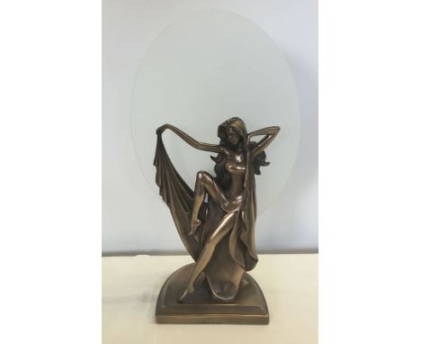 An Art Deco style lamp with glass oval shade behind a figure of a lady, approx 46cm high.