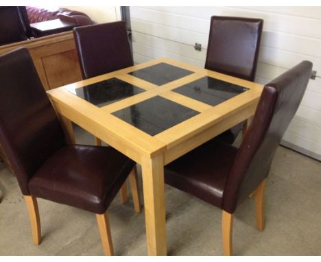 A light oak square dining table with black marble tile inserts and 4 faux leather chairs. Table 90cm square.