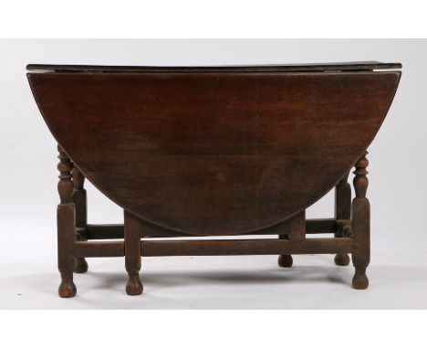 18th Century oak gateleg table, the oval top on bobbin turned legs and flattened stretchers, 124cm wide