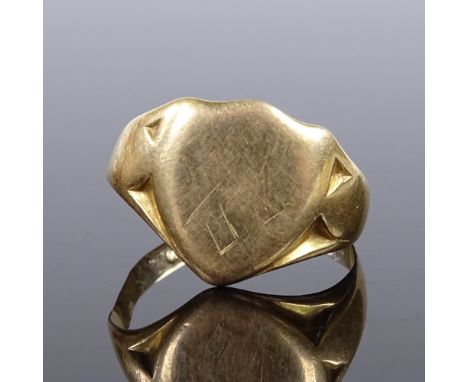 An 18ct gold shield-shaped signet ring, maker's marks JH, panel height 13.2mm, size O, 4.8g (shank A/F) 