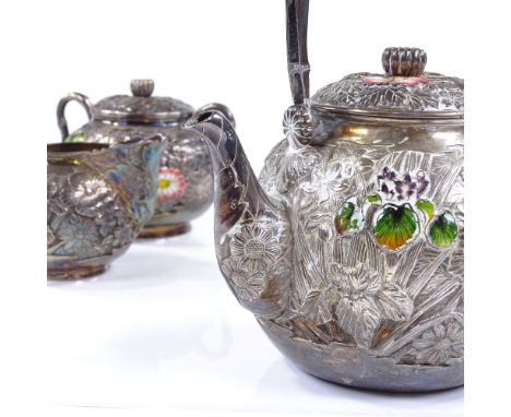 An Oriental silver 3-piece tea set, with all over relief embossed floral decoration, and applied coloured enamel high points,