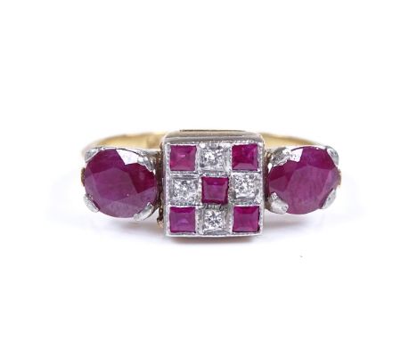 An 18ct ruby and diamond dress ring, with chequered square central panel flanked by 2 oval-cut rubies, setting height 7.4mm, 
