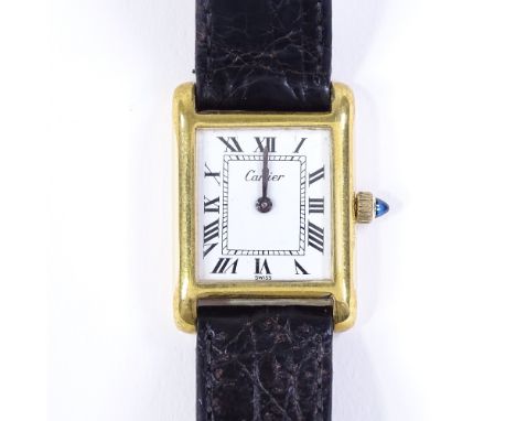 A lady's 18ct gold plated Cartier manual wristwatch, with white face and Roman numeral hour markers, case width 20mm