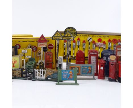 A collection of die cast signs, telephone boxes, post boxes, and 2 boxed sets of Dinky road signs 