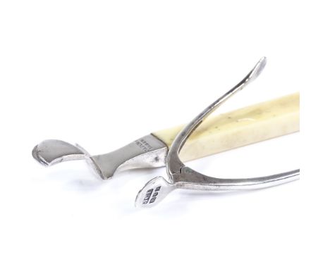 A silver and ivory-handled orange peeler, by Hukin &amp; Heath, hallmarks London 1910, length 12cm, together with a pair of s