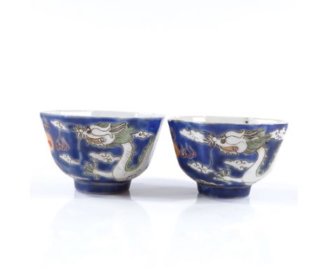 A pair of Chinese blue and red glaze porcelain tea  bowls, with hand painted dragon enamel decoration, diameter 5.5cm 