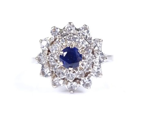 An 18ct white gold sapphire and white stone cluster ring, setting height 15.2mm, size M, 5g 