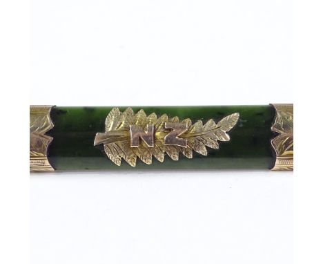 A New Zealand nephrite jade and 9ct gold-mounted brooch, with central fern decoration, length 57.7mm, 7.6g 