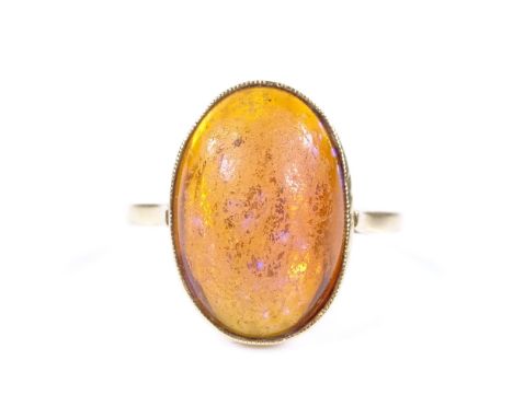 An 18ct gold cabochon fire opal ring, opal measures 15.83mm x 10.72mm x 5.41mm, size L, 4.7g 