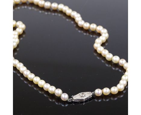 A single string graduated pearl standard long necklace, on 9ct white gold clasp set with a single diamond, necklace length 18