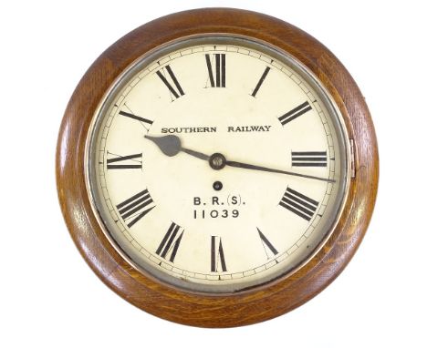 An early 20th century oak-cased railway dial clock, painted dial with 8-day movement, supplied by Stockall, Marples &amp; Co,