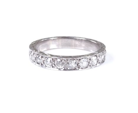 An 18ct white gold half eternity ring, with foliate engraved bridge, total diamond content approx 1ct, band width 3.9mm, size