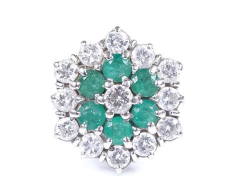 An unmarked white gold emerald and diamond cluster cocktail ring, total diamond content approx 1.9ct, central stone approx 0.