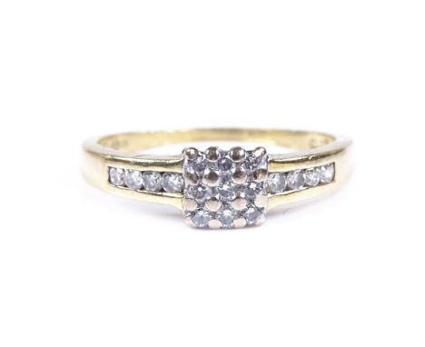 An 18ct gold diamond cluster ring, with channel set diamond shoulders, total diamond content approx 0.33ct, setting height 5.