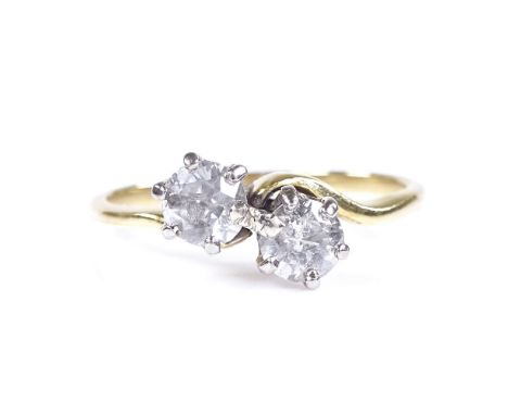 An unmarked gold 2-stone diamond crossover ring, settings test as 18ct gold, total diamond content approx 0.7ct, size P, 3.2g