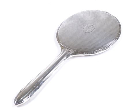 A large sterling silver dressing table hand mirror, with gadrooned border and engine turned decoration, length 33cm 