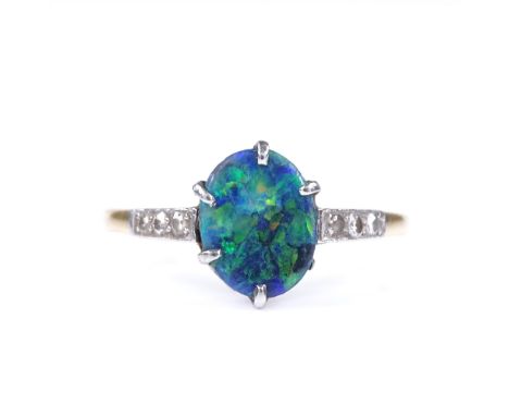 An 18ct gold black opal panel ring, with diamond set shoulders, opal measures 9.7mm x 7.72mm x 4.31mm, size T, 2.6g 