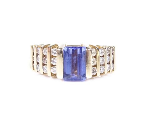 A 14ct gold tanzanite solitaire ring, with channel set diamond shoulders, tanzanite length 7mm, size N, 6.1g 