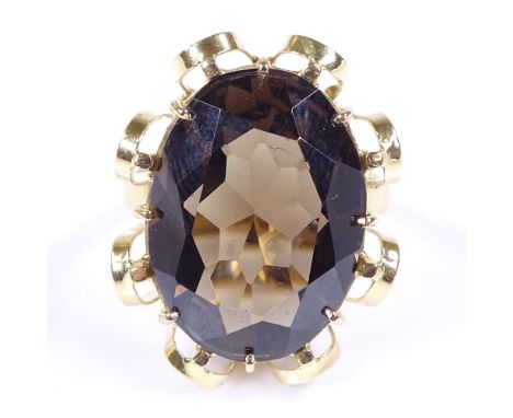 A large 14ct gold oval-cut smoky quartz dress ring, setting height 26.5mm, size N, 9.1g 