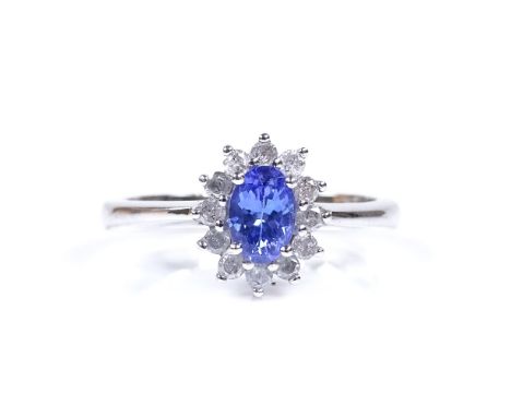 A 9ct white gold tanzanite and diamond cluster ring, total diamond content approx 0.25ct, setting height 10.4mm, size N, 3.2g