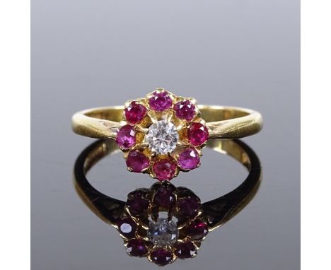 An 18ct gold ruby and diamond cluster flowerhead ring, setting height 9.1mm, size N, 2.9g 