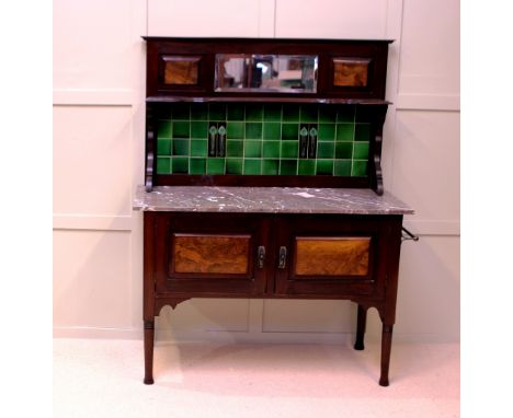 AN EDWARDIAN WALNUT AND MAHOGANY TILE BACK WASHSTAND W 107 CM H 136 CM D 43 CM