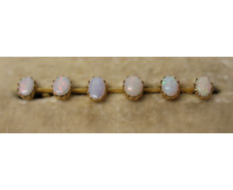 A YELLOW METEL AND SIX OPAL BROOCH, WEIGHT 4.1G, LENGTH 6.5CM