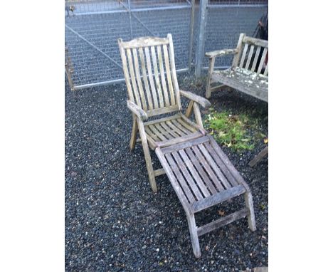 A pair of teak garden loungers