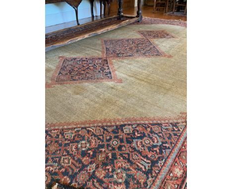 A Fereghan carpet, West Persia, the camel field with a triple linked indigo herati designed lozenge medallions, herati spandr