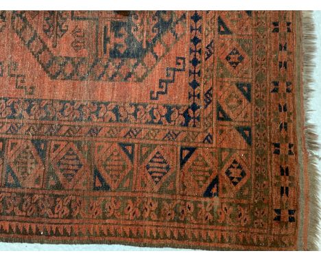 An Afghan carpet with six rows of three octagonal medallions within a serrated leaf lozenge border. (Dimensions: 378cm x 271c