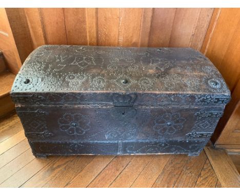 An 18th century metal bound and leather covered wooden dome top trunk with studded decoration throughout, the top initialled 