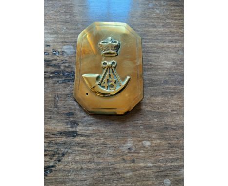 A military brass plate, decorated with a crown above a 43 bugle. (Dimensions: Height 15.5cm, width 10.5cm)(Height 15.5cm, wid