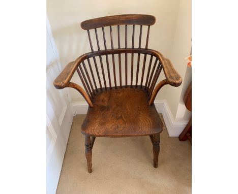 An ash and elm stick filled Windsor armchair, the dished seat on turned tapering legs. (Dimensions: Height 85cm)(Height 85cm)