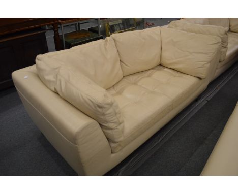 A Roche Bobois cream leather two seater sofa.