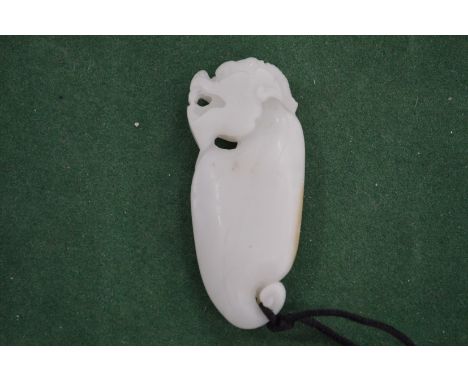 A carved jade amulet.
