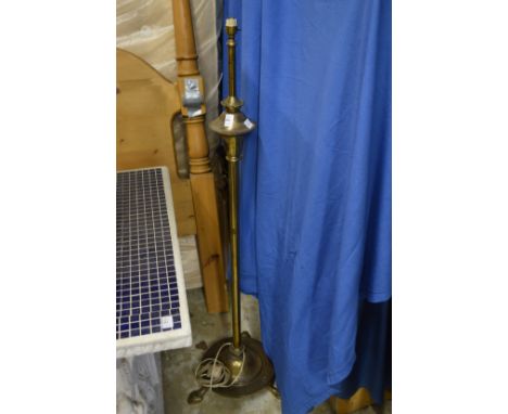A brass floor standing lamp.