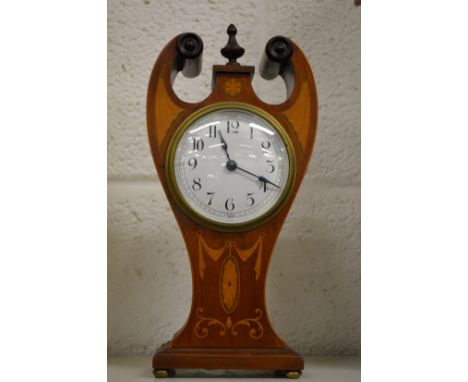 An Edwardian inlaid mahogany mantle clock.