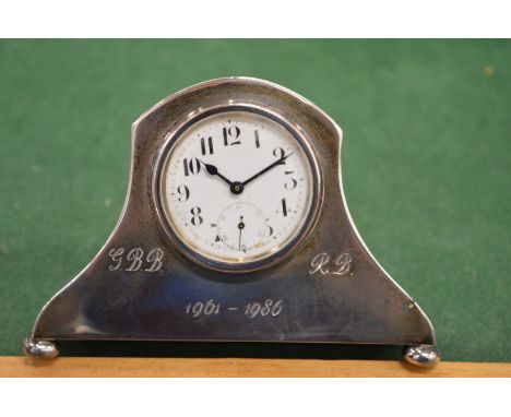 A silver desk clock.