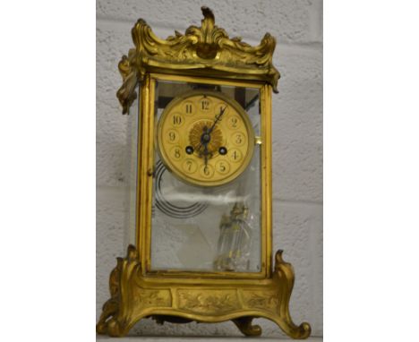 An ormolu four glass mantle clock with mercury pendulum.