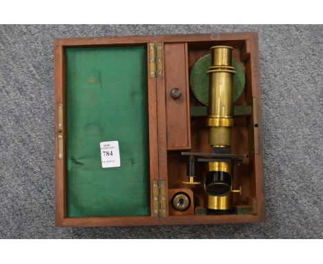 A mahogany cased brass microscope.