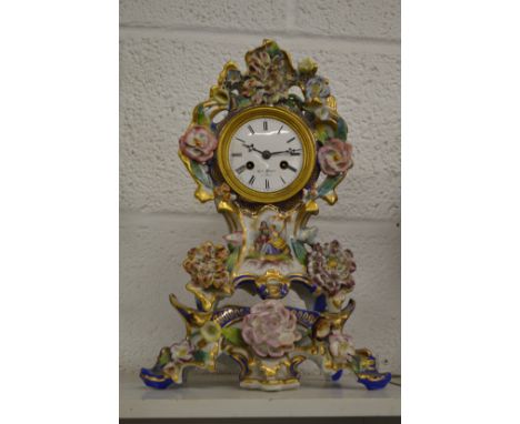 A French porcelain mantle clock on matching stand.