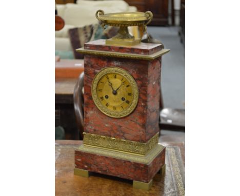 A good Regency rouge marble and ormolu mantle clock with urn finial.