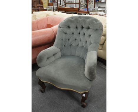 A Victorian button back armchair.