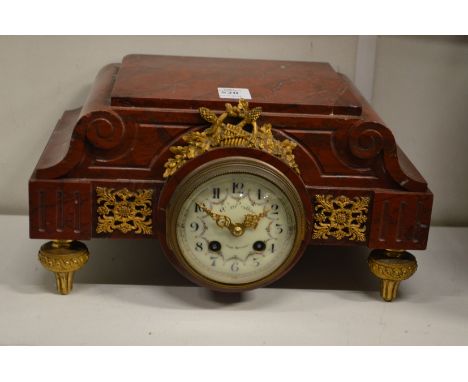 A 19th century French rouge marble and ormolu mounted clock.