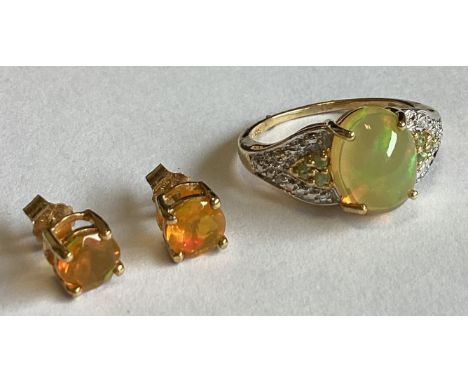 A good fire opal set ring together with matching ear studs in 9 carat setting. Approx. 4 grams. Est. £100 - £150.