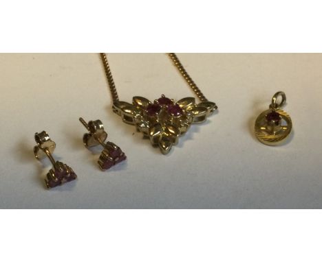 A 9 carat ruby pendant together with matching earrings. Approx. 5 grams. Est. £70 - £80.