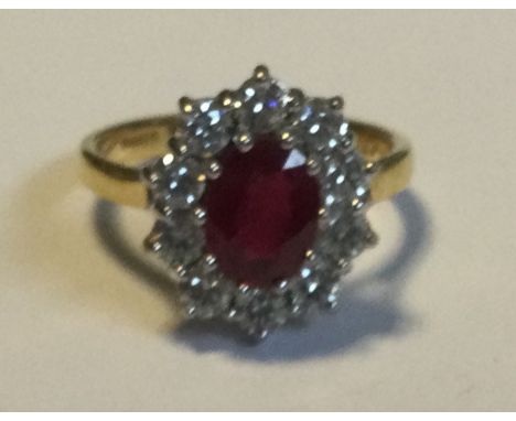 A good ruby and diamond oval cluster ring in 18 carat two-colour gold mount. Approx. 5 grams. Est. £150 - £200.