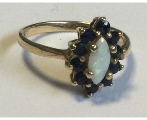 A small opal and sapphire ring in 9 carat mount. Approx. 3 grams. Est. £30 - £50.